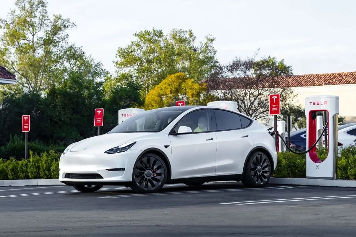 white Tesla using Supercharger
