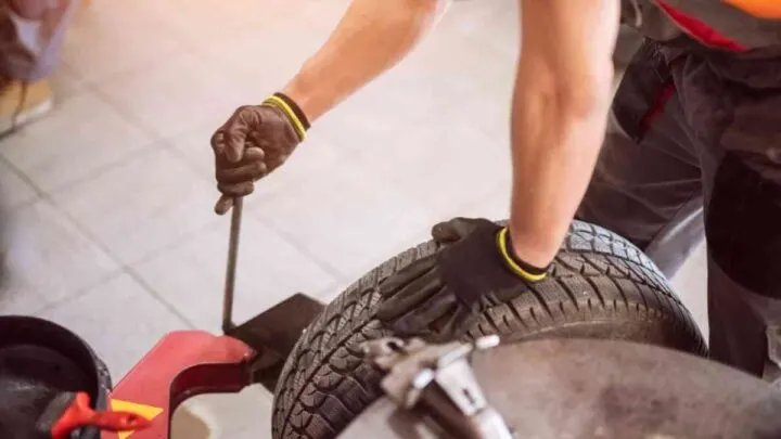 mechanic replacing car tire