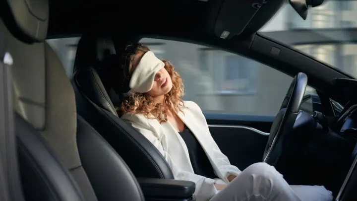 Woman sleeping using a self-driving mode 