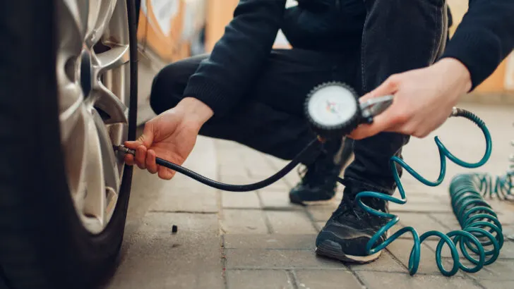 Male checks the tire pressure